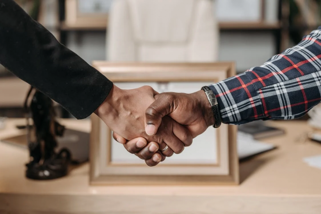 Two individuals shaking hands