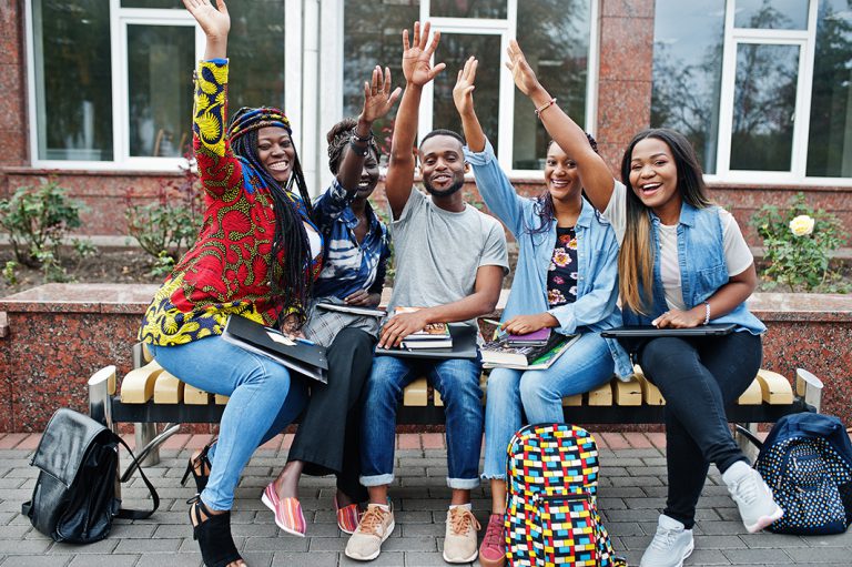 group-five-african-college-students-spending-time-together-campus-university-yard-black-afro-friends-studying-bench-with-school-items-laptops-notebooks2